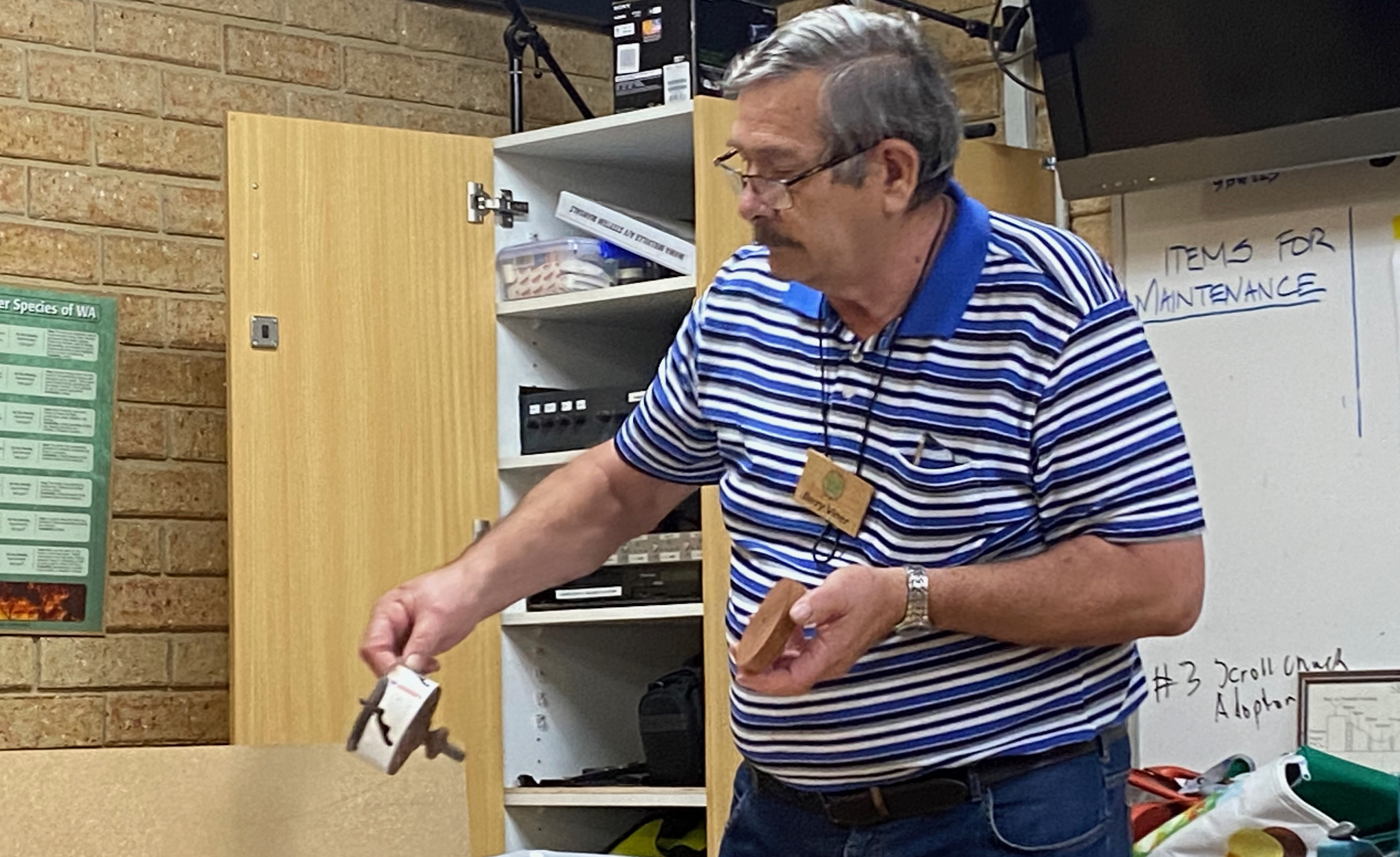 Photo of Barry showing the hole saw that he uses to create the wheels