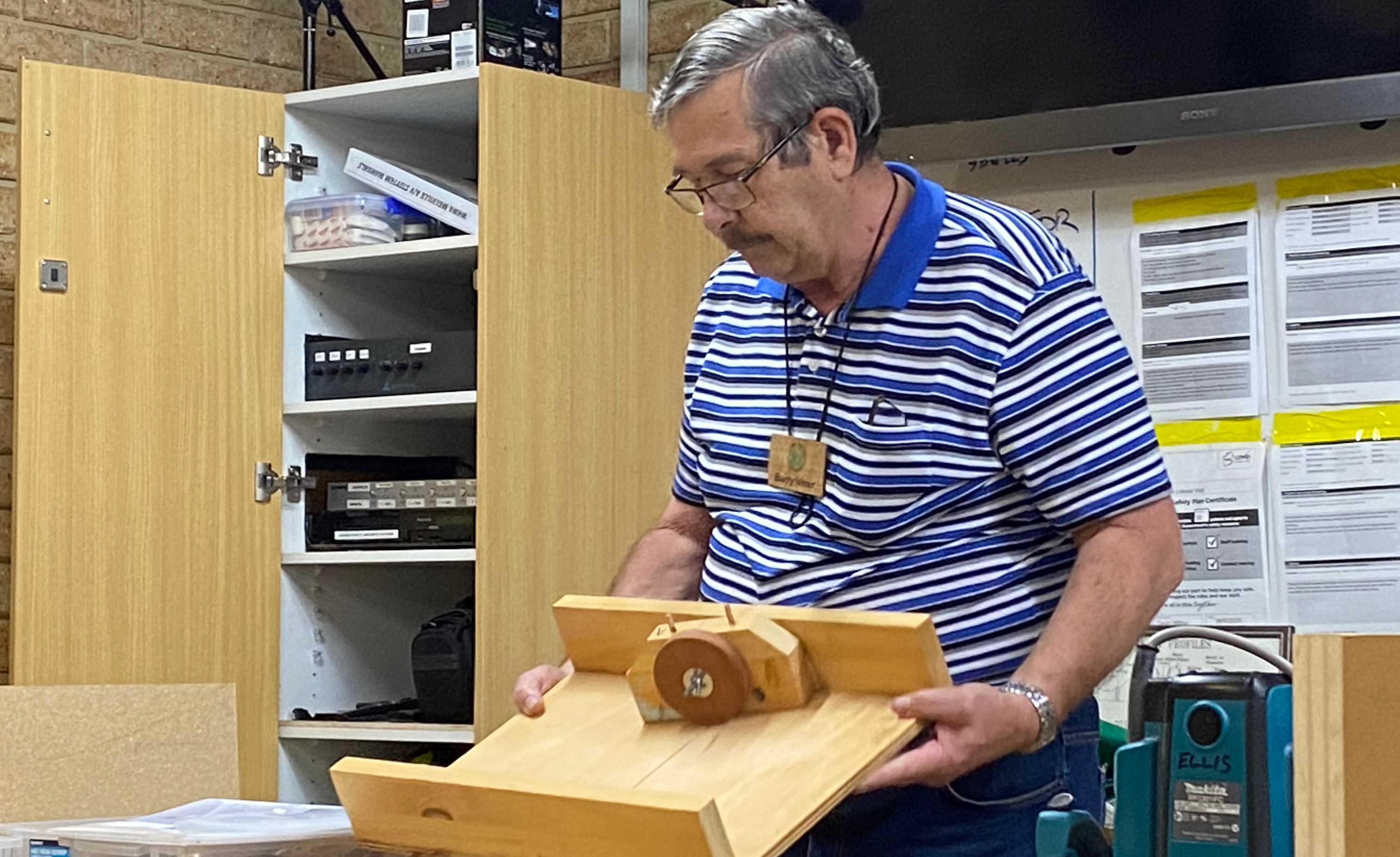 Photo of Barry explaining the tablesaw sled with custom jig that he uses for cutting the grooves