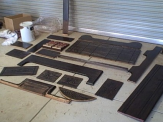 The re-covered pedals, and some of the larger case parts drying after staining and varnishing