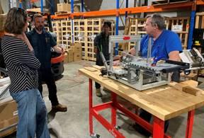 Photo of FWWA members discussing the panto router with Dane from Timbecon