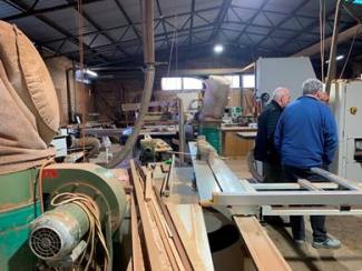 Photo showing members looking a machinery in the machine shop