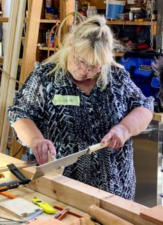 Photo of Gloria working on the dovetails