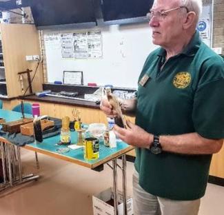 Martin talking about marquetry while holding a sample