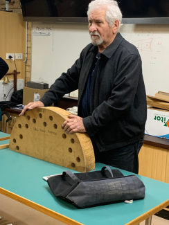 Photo of Stan showing the form he uses for creating the curved front on his demi-lune table